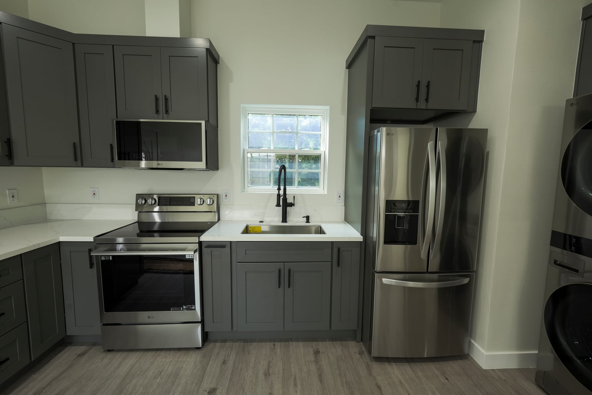 Gray kitchen with a peninsula and window-lit sink