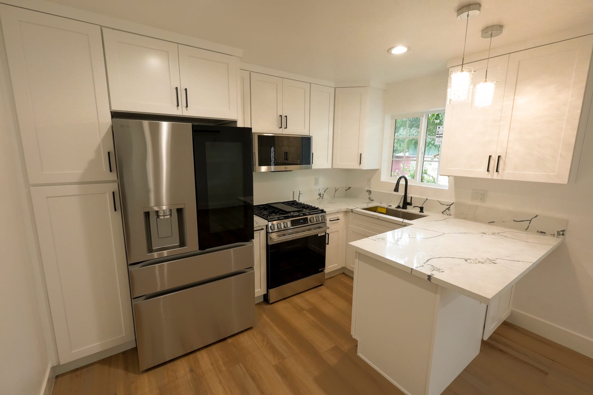 Bright white kitchen with a generous island and pendant lighting