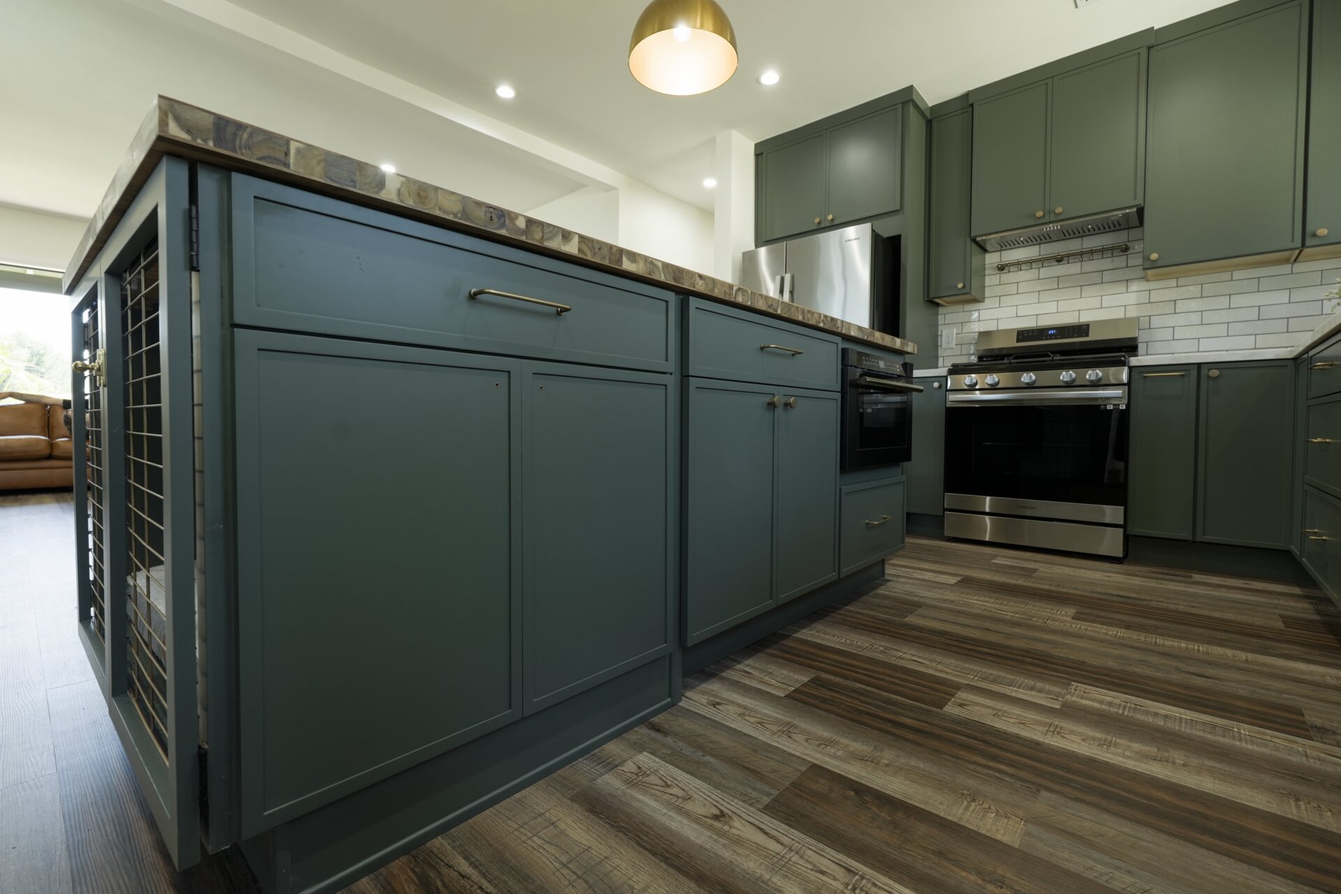 Low-angle view of the green island and wood countertop