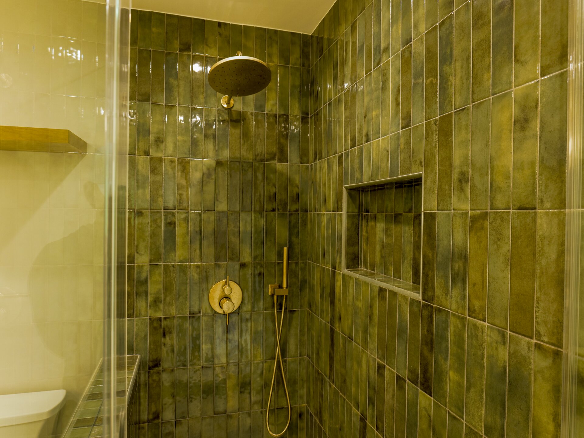 Stone shower tile with a recessed niche