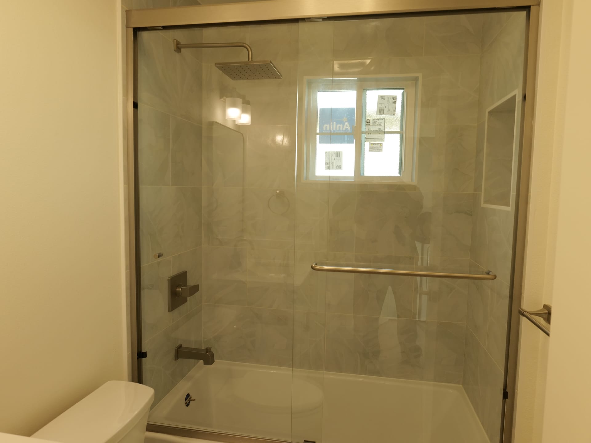 Tiled shower enclosure beneath a high window